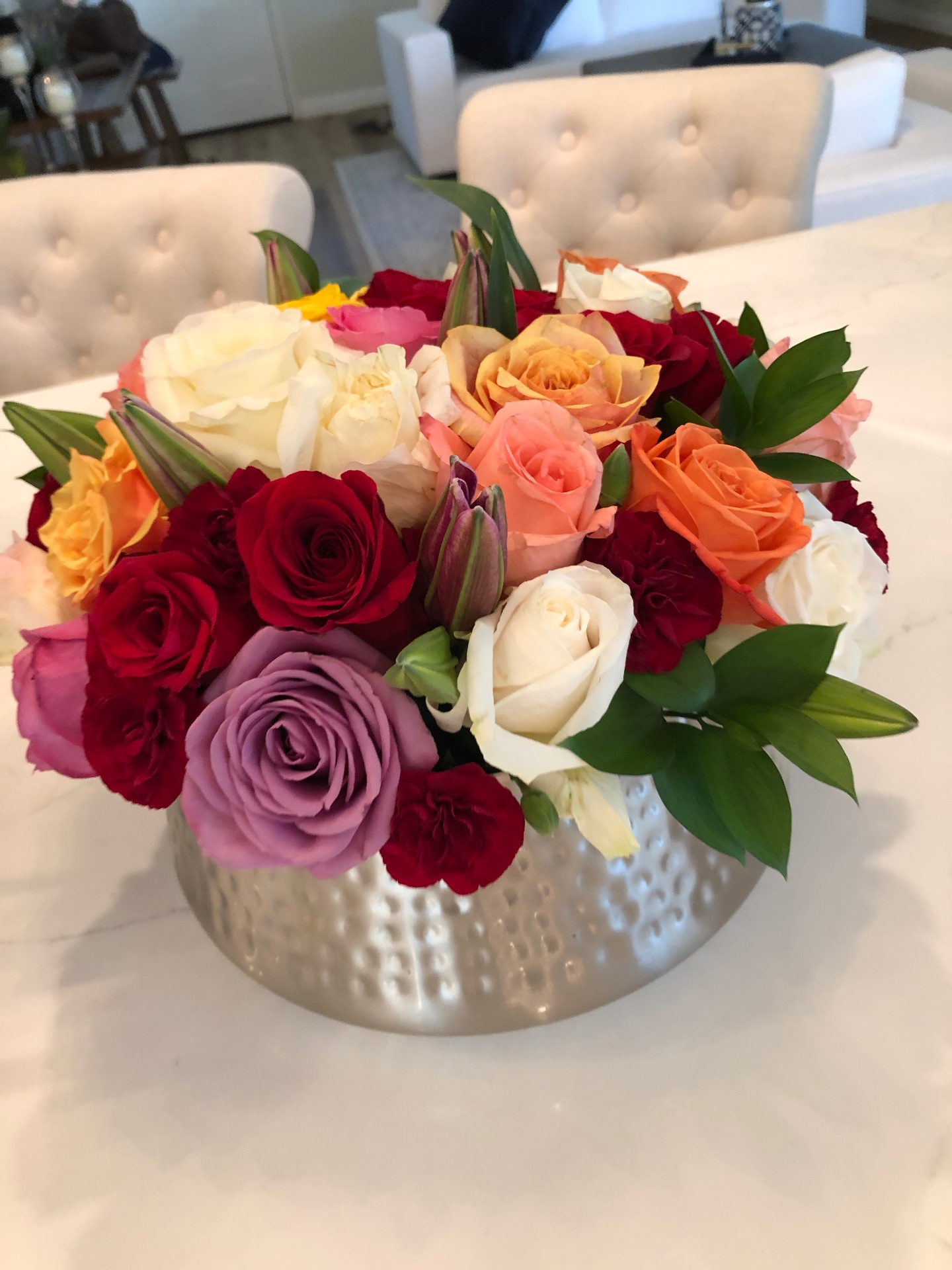 Mixed rose centerpiece in hammered vessel