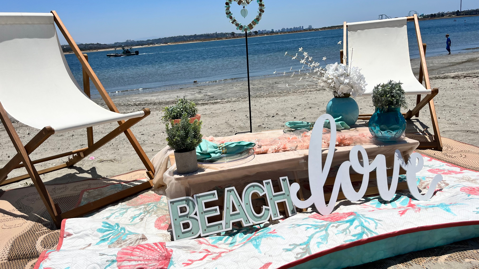 "Beach Love" waterfront setup with picnic styling