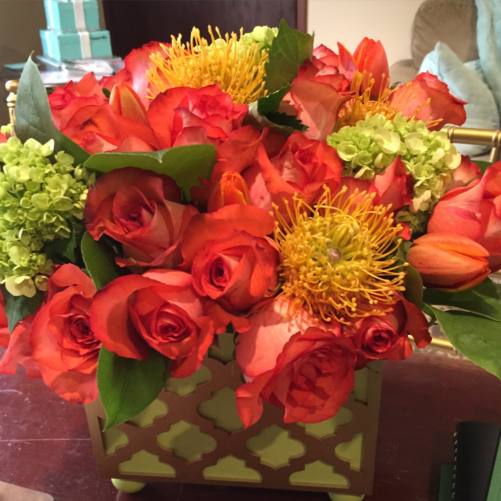 Orange roses, pincushion proteas & hydrangea in a Moroccan box